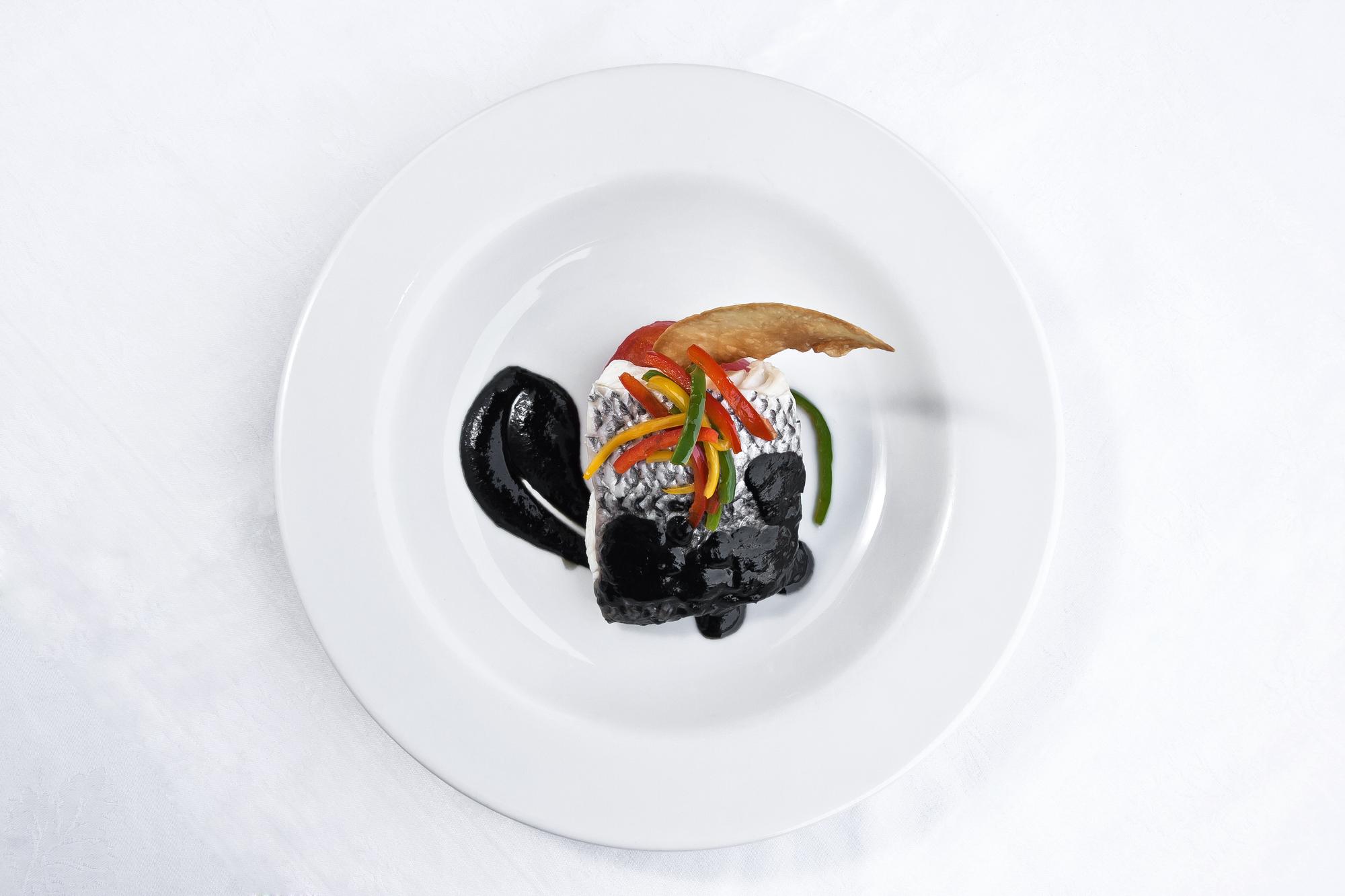 Sample plated tasting menu displayed on black table